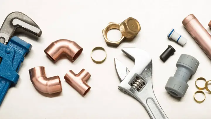 Pipe wrench, copper fittings and plumbing repair tools